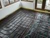 500 gauge slip membrane vapour barrier over Celotex RRFL floor insulation board and edge insulation, conforming to BRE recommendations, laid prior to installation of underfloor heating loops