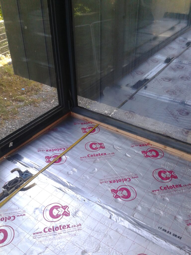Flooring grade insulation, with measurements being taken prior to the underfloor heating pipework being installed to accommodate in-floor sockets